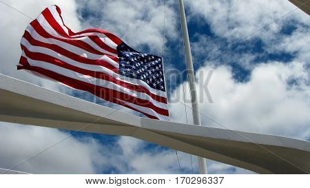 American flag flying over the USS Arizona Memorial in Honolulu, Hawaii