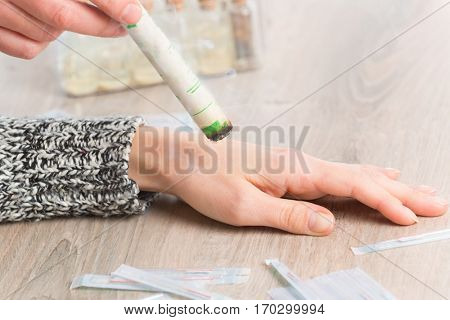 Alternative medicine therapist doing moxa treatment on her client