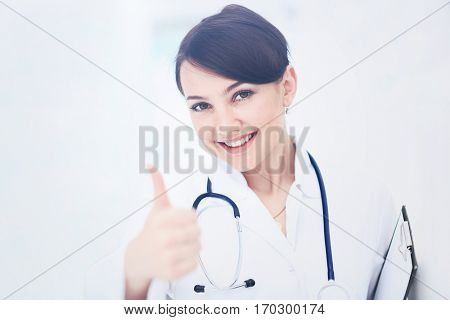 A female doctor shows a sign okay