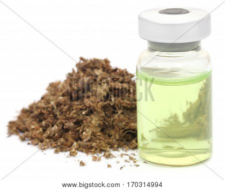 Medicinal cannabis with medicinal drug in a vial over white background