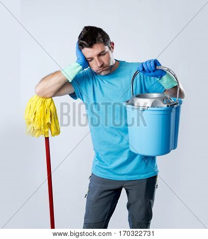 portrait young domestic service cleaner man or stressed husband doing housework washing home holding mop and bucket in stress desperate and overworked in boring cleaning work