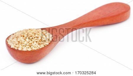 Peeled sesame seeds in a wooden spoon