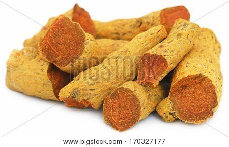 Close up of Whole turmeric over white background