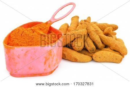 Whole and ground turmeric in a vintage container