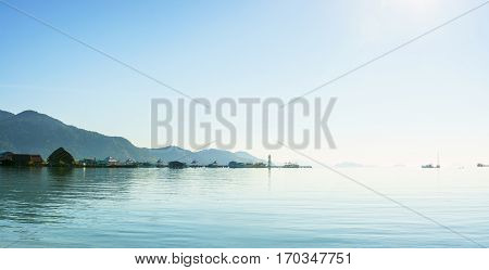 Panorama scenic view sunrise of the harbor with mountain background against cloudy sky at Bang-Bao Koh Chang Island (Thailand).