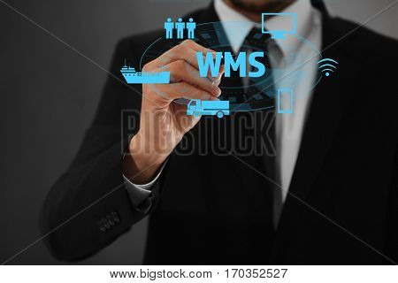 Warehouse management system concept. Man working with virtual screen