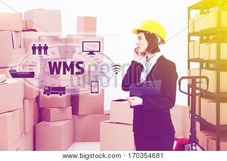 Warehouse management system concept. Woman working at factory facility