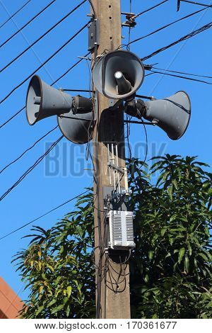 Loudspeakers broadcast wirelessly installed on electric poles.