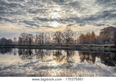 Surface of the autumn river. Dawn. Oakwood.