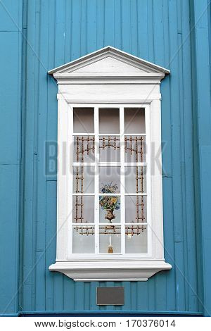 blue wall white window curtain vase candle holder