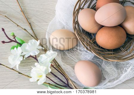 hen's eggs in wicker basket and willow to the Easter holiday