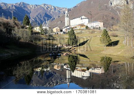 the smallest municipality of Italy called LAGHI with the little lake and the church with steeple