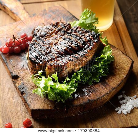 juicy grilled steak with spices on a cutting board.