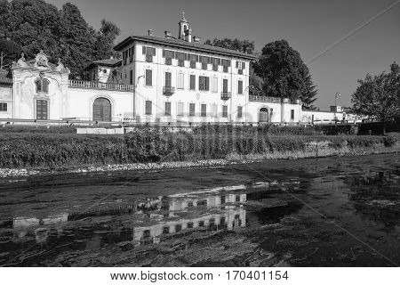 Cassinetta di Lugagnano (Milan Lombardy Italy): facade of the historic Villa Visconti Maineri along the canal known as Naviglio Grande of Turbigo. Black and white