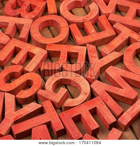 Surface coated with the multiple painted wooden block letters as an abstract backrop composition