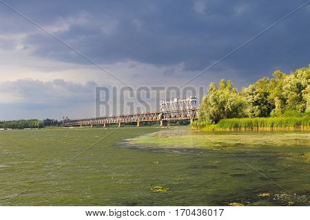 Bridge across river Dnieper in Kremenchug and storm clouds in sky