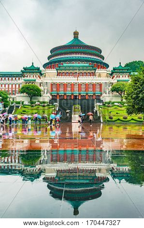 CHONGQING CHINA - September 19 2015: The Great Hall of the People in central of Chongqing was in raining day with tourist raise an umbrella The one of the architectural landmark of Chongqing.