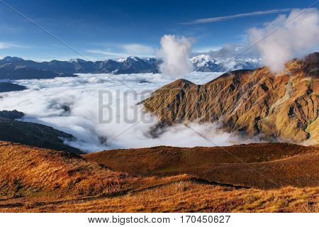 Snow-covered mountains in the mist. Autumn at Koruldi Lake. Europe, Georgia, Upper Svaneti, near mt. Ushba.