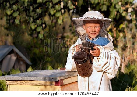 Beekeeper a young boy who works in the apiary. Beekeeping
