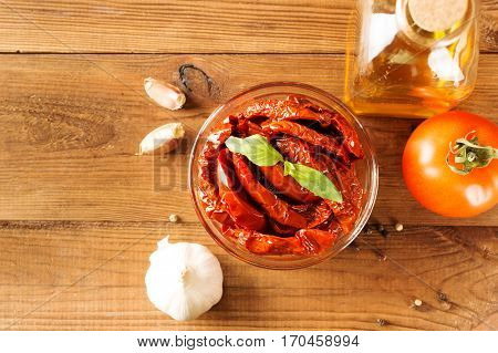 Italian appetizer - sundried tomato in bowl on the wooden table.