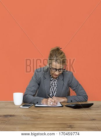 Businesswoman writing down a plan and strategy