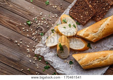 Black and white rooty with herbs on table with seeds