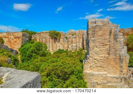 Old abandoned stone quarry Lithica Pedreres des Hostal, Menorca island, Spain. Popular place to take a walk.