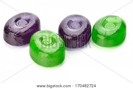 Four colorful fruit hard sugar candies,  boiled sweeties or sugar plums isolated on white background cutout