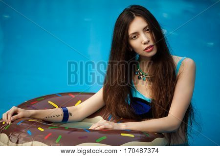 Girl in bathing suit standing in a pool of water