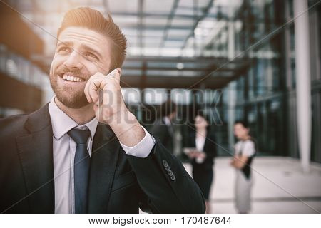 Businessman talking on mobile phone in office premises