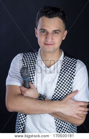 Young Male Black-haired Pop Singer Performs Singing To Microphone