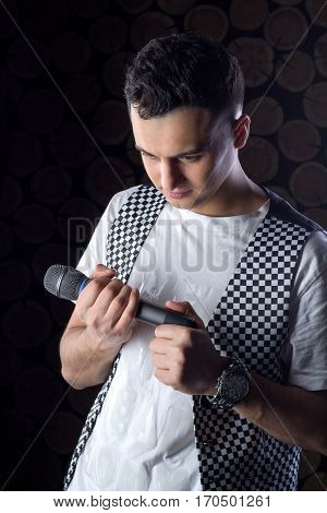 Young Male Black-haired Singer Performs With Microphone