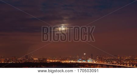 Kiev. Moon over the city cityscape.ukraine skyline