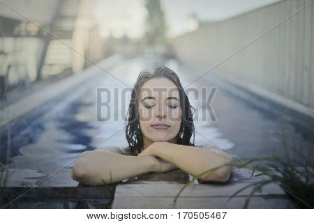 Relxing girl in the pool