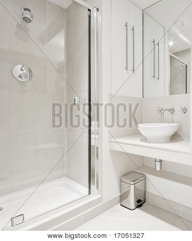 modern bathroom with white ceramic appliances and shower cabin