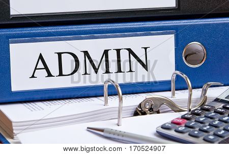 Admin - blue Administration binder on desk in the office