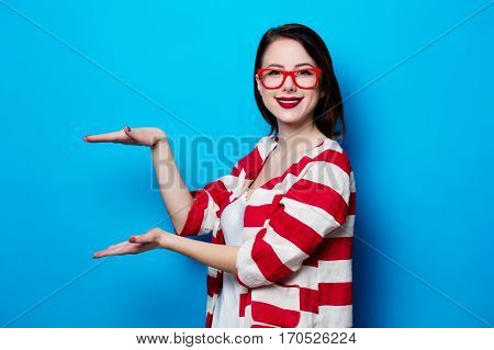 Portrait Of The Beautiful Young Smiling Woman On The Blue Background