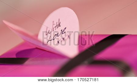 Valentines with love message on heart shaped card on present