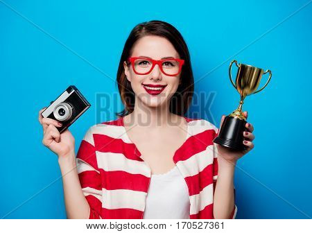 Woman With Cup Trophy And Retro Camera