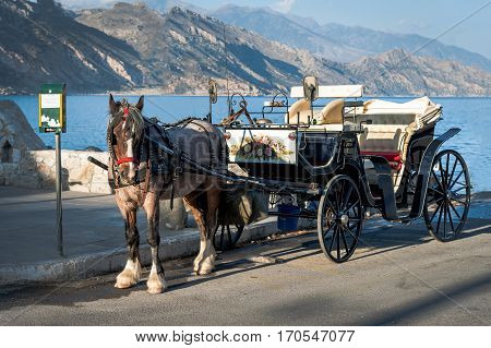Horse carriage is staying in port of Paleochora town, Crete island, Greece