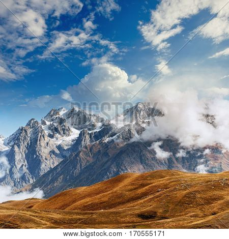 Snow-covered mountains in the mist. Autumn at Koruldi Lake. Europe, Georgia, Upper Svaneti, near mt. Ushba.
