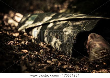 Dead Body Of A Teenage Boy Lying In A Forest