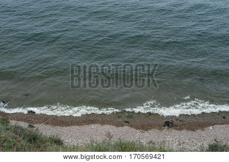 Waves lap the vast Lake Baikal on the wild coast.