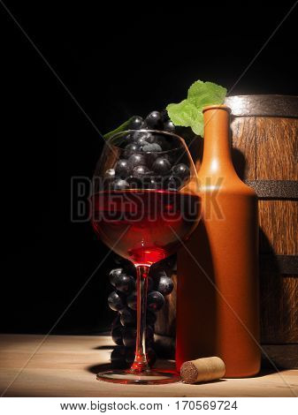 Glass Of Red Wine And Barrel On Wooden Table