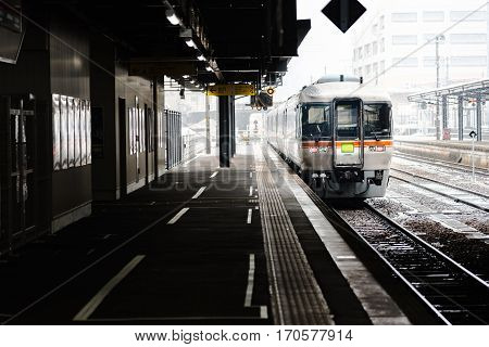 Close up of local train arrive to railway station in the winter Japan.