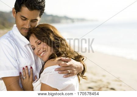 Portrait of a beautiful Hispanic couple laughing and smiling.
