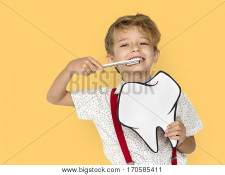 Little Boy Brushing Teeth Holding Papercraft Tooth