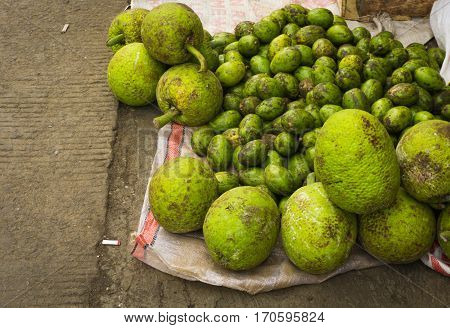 Bread fruit and ambarella on top of plastic sack sold in traditional market in Bogor Indonesia java