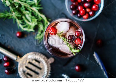 cranberry and rosemary cocktail in flay lay composition