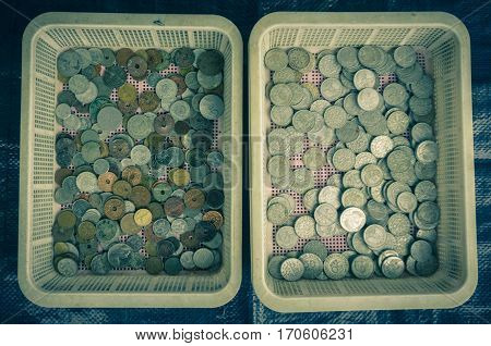 Collection of indonesia's coins displayed on a plastic basket photo taken in Bogor Indonesia java